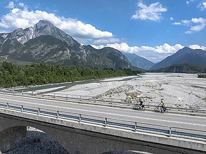 Cyclists on the bridge of Tagliamento river