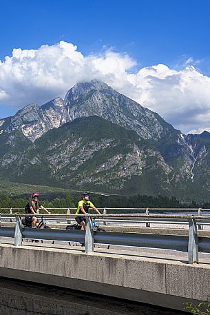 Cyclists on the bridge of Tagliamento river