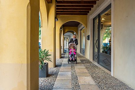 Pushing a stroller on the streets of Sacile
