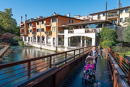 Pushing a stroller on the streets of Sacile