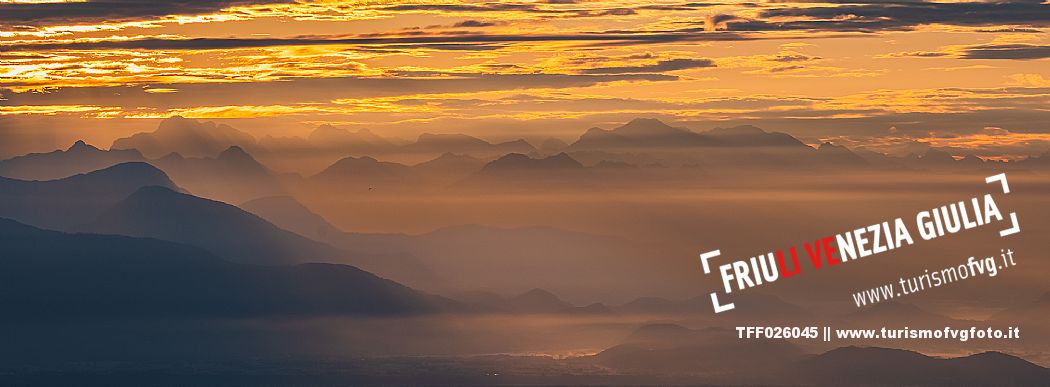 Sunrise on the Friulian plain from Piancavallo (Castaldia). On the background the mountain range of Carnia and Julian Alps 