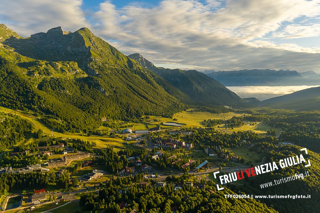 The town of Piancavallo seen from above. In the background the Cima del Cavallo and on the right the Friulian Dolomites and Valcellina