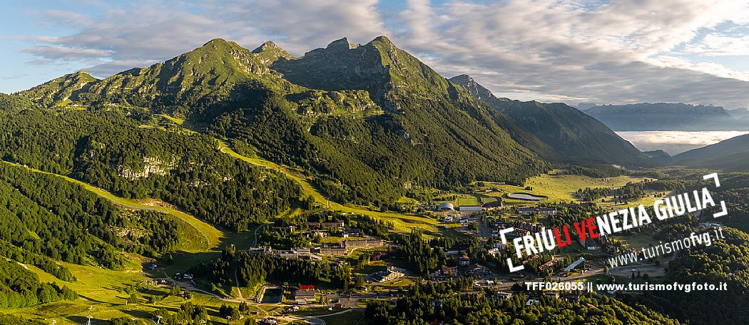 The town of Piancavallo seen from above. In the background the Cima del Cavallo and on the right the Friulian Dolomites and Valcellina