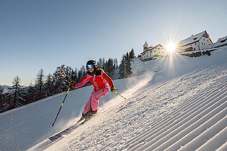 Alpine ski action with a skier woman at Di Prampero slope on Lussari Mount. Alpine ski action with a skier woman at Di Prampero slope on Lussari Mount.