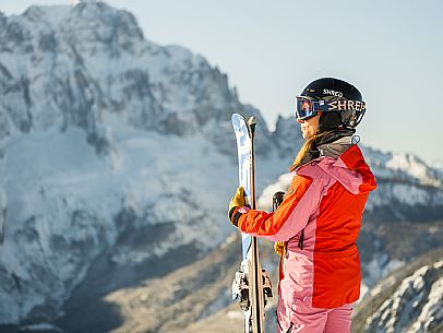 Alpine ski with joung skier woman. Di Prampero slope on Lussari Mount.