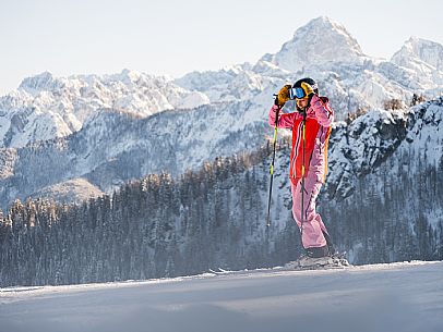 Alpine ski with joung skier woman. Di Prampero slope on Lussari Mount. Alpine ski with joung skier woman. Di Prampero slope on Lussari Mount.