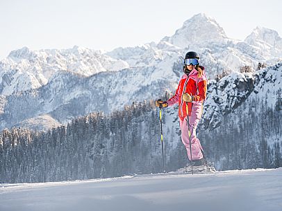 Alpine ski with joung skier woman. Di Prampero slope on Lussari Mount. Alpine ski with joung skier woman. Di Prampero slope on Lussari Mount.