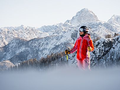 Alpine ski with joung skier woman. Di Prampero slope on Lussari Mount. Alpine ski with joung skier woman. Di Prampero slope on Lussari Mount.