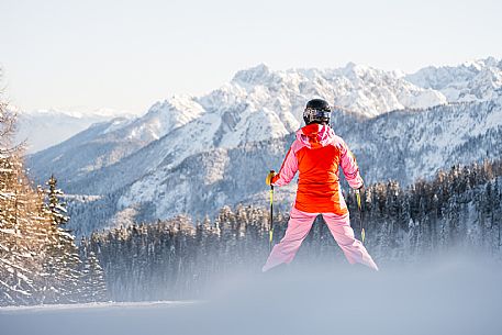 Alpine ski with joung skier woman. Di Prampero slope on Lussari Mount. Alpine ski with joung skier woman. Di Prampero slope on Lussari Mount.