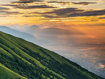 Sunrise on the Friulian plain from Piancavallo (Castaldia). On the background the mountain range of Carnia and Julian Alps 