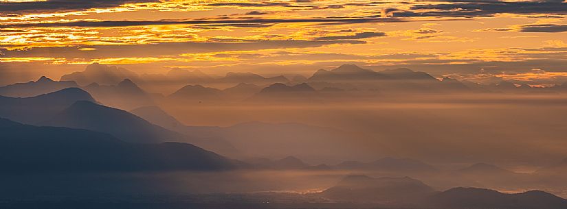 Sunrise on the Friulian plain from Piancavallo (Castaldia). On the background the mountain range of Carnia and Julian Alps 