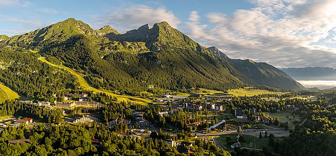 The town of Piancavallo seen from above. In the background the Cima del Cavallo and on the right the Friulian Dolomites and Valcellina