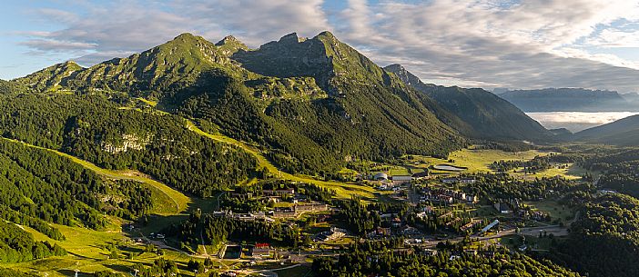 The town of Piancavallo seen from above. In the background the Cima del Cavallo and on the right the Friulian Dolomites and Valcellina