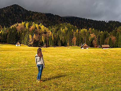 The meadows of Val Bartolo. Here you can immerse yourself in greenery, an expanse of meadows dotted with traditional mountain huts, characterised by wood and sloping roofs with balconies adorned with flowers. Landscapes and trekking in autumn.