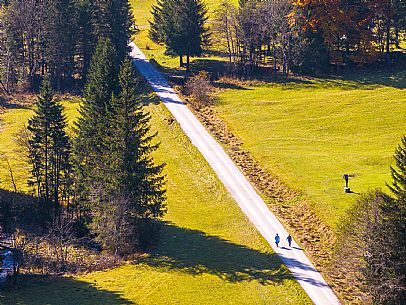 The meadows of Val Bartolo. Here you can immerse yourself in greenery, an expanse of meadows dotted with traditional mountain huts, characterised by wood and sloping roofs with balconies adorned with flowers. Landscapes and trekking in autumn.